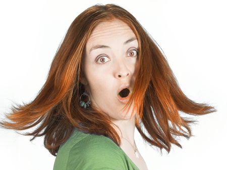 Beautiful surprised woman with couloured hair in movement over white