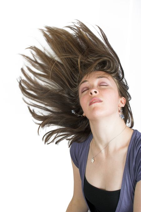 beautiful fashionable woman with moving hair over a white background