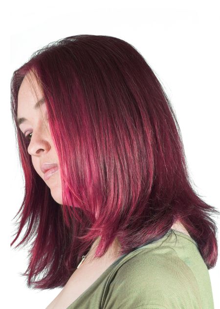 Pretty, calmed woman with couloured hair over white background