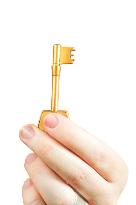 Hand holding a key of success over a white background