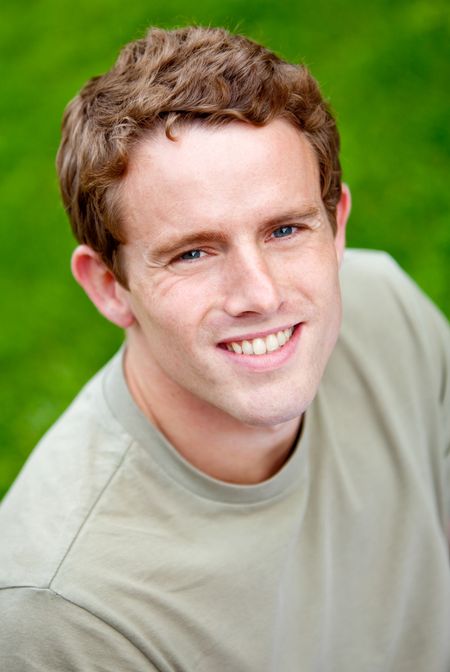Portrait of a young man smiling outdoors