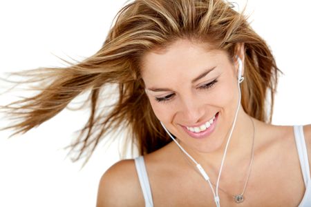 Woman with earphones listening to music - isolated over a white background