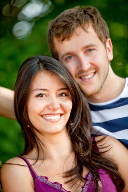 Portrait of a beautiful couple smiling outdoors