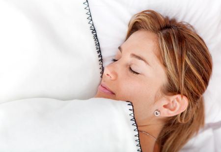 Beautiful woman portrait sleeping in bed and covered with blankets