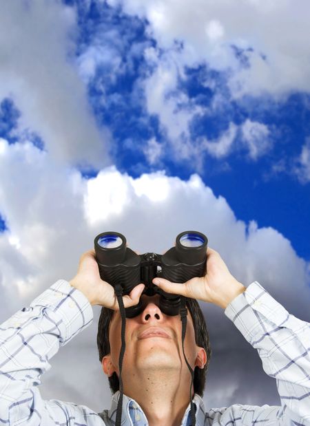 business man searching for something with the sky at the background