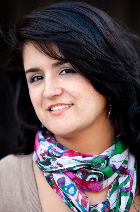 Casual woman portrait smiling over a black background