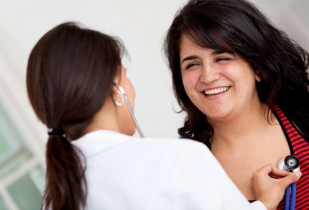 Doctor checking the heart of a patient with a stethoscope