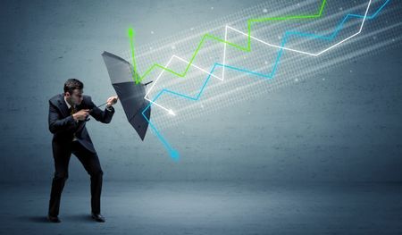 Business person with umbrella and colorful stock market arrows concept