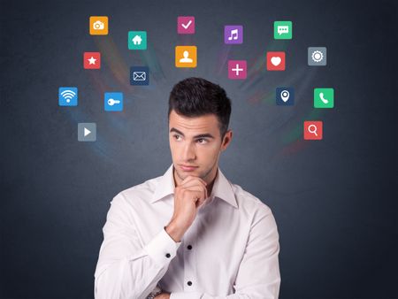 Young casual businessman with colorful applications over his head