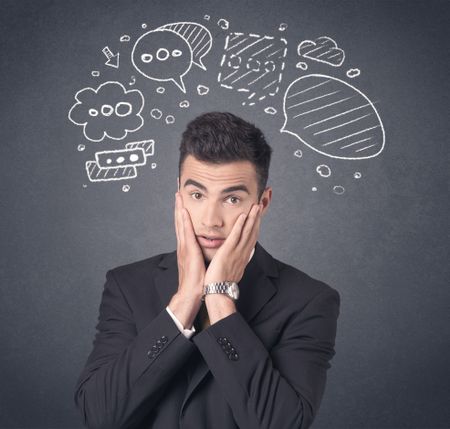 Young businessman with drawn speech bubbles over his head