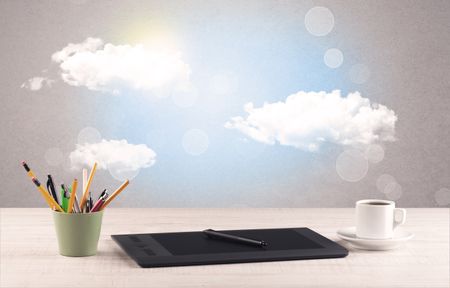 Close up of business office desk concept with clouds, blue sky and sunshine