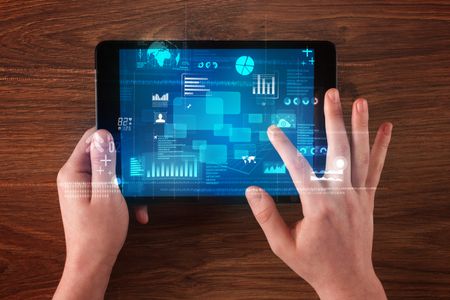 Caucasian business hands holding tablet with blue business-statistics screen