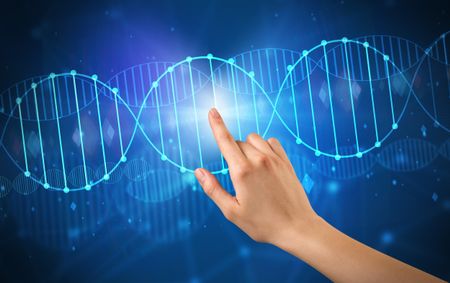 Female hand touching DNA molecule with blue background