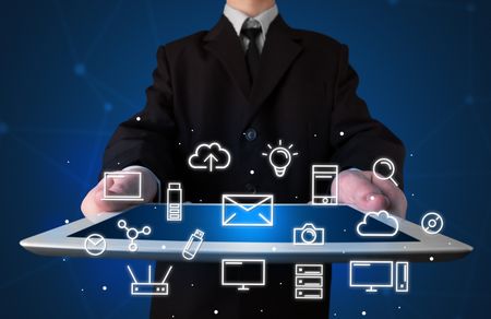 Businessman holding tablet with multimedia icons
