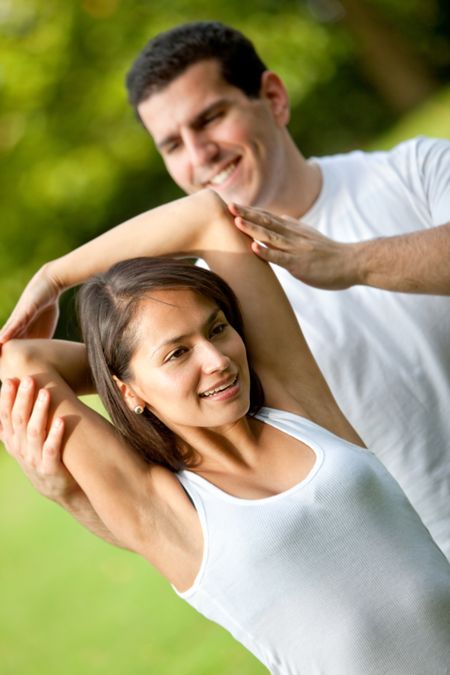 fit-woman-sports-trainer-stretching-outdoors-60991045 Fit woman and her sports trainer stretching outdoors