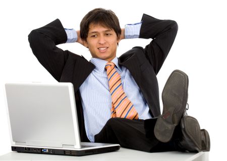 business man relaxed at work on his desk watching a laptop screen isolated over a white background