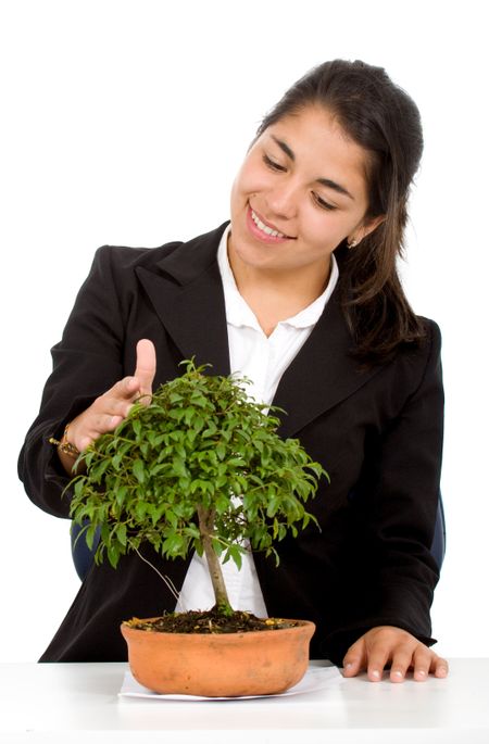 protect your investments - business woman looking after a tree isolated over a white background