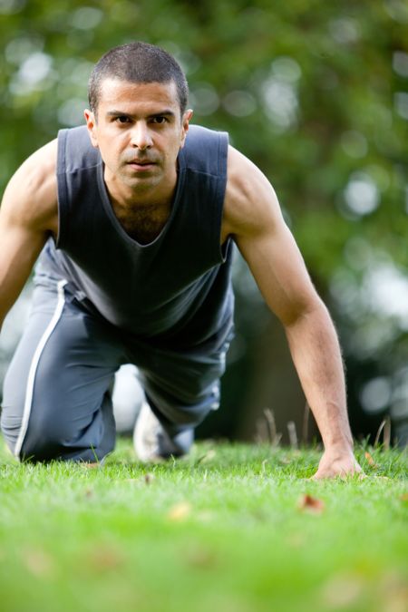 Handsome man exercising at the park - fitness concepts