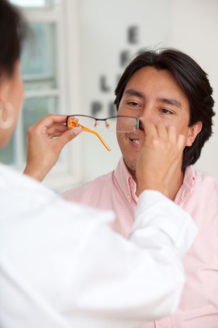 Man at the optometrist trying his new glasses