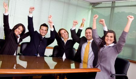 business team at the office all celebrating their success