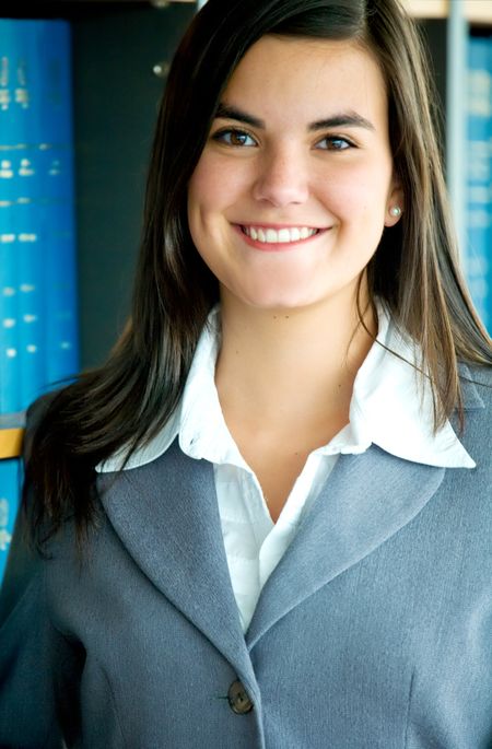 Business woman portrait smiling in an office - hispanic