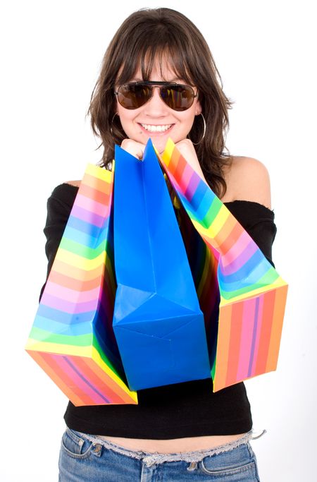 happy girl smiling holding shopping bags wearing sungglases - isolated over a white background