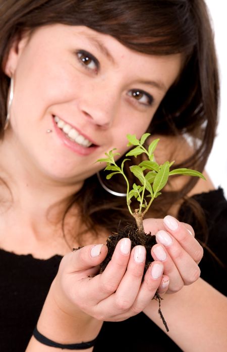 girl with a tree on her hands looking after the environment - focus is on hands