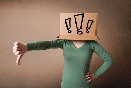 Young lady standing and gesturing with a cardboard box on her head with exclamation point