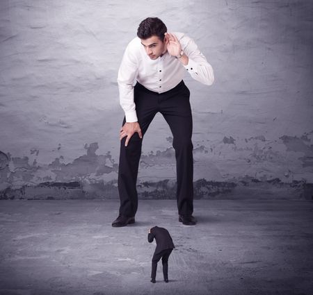 Angry big manager looking at small business man concept on background