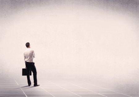 Office worker with briefcase standing with his back facing an empty space with filtered color concept