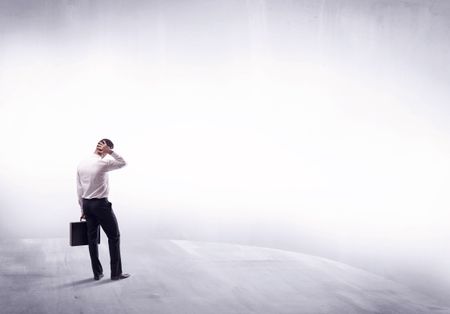 Young sales businessman in elegant suit standing with his back in empty white space background concept