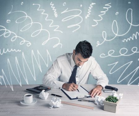 An elegant businessman sitting at office desk and working on keyboard with drawn curves, lines illustration on background wall concept
