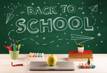 Back to school concepty with writing on blackboard and desk, apple, books, items