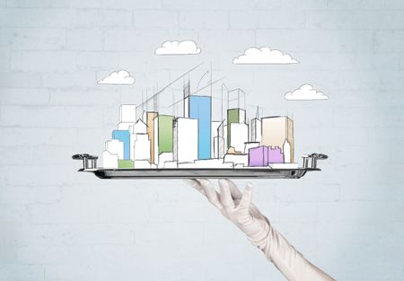 Serving a city concept with close up of waiter hand in gloves holding silver plate in front of grey brick wall