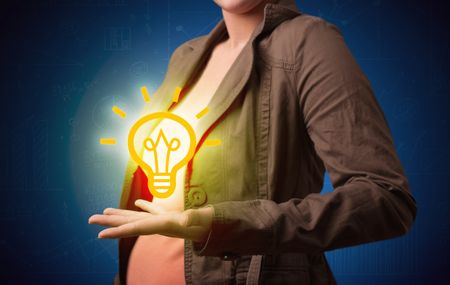 A creative businessman has a great bright idea illustrated by holding a drawn light bulb in the hand concept