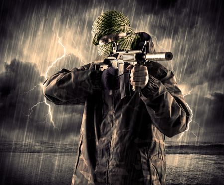 Portrait of a dangerous armed terrorist with mask and gun in a thunderstorm with lightning