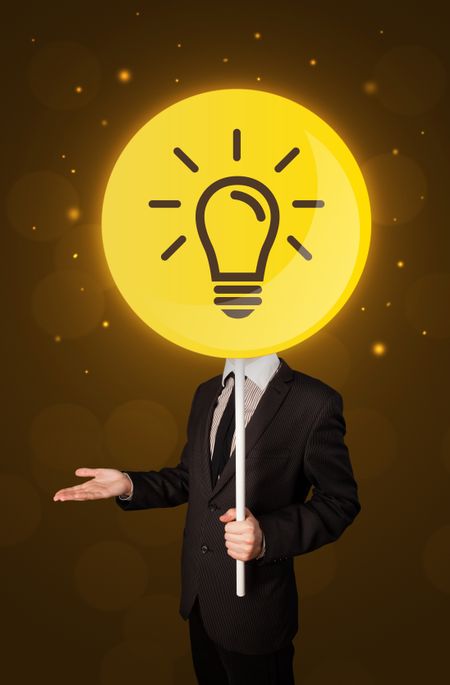 Smart businessman holding round sign with yellow lightbulb 