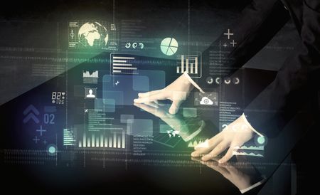 Businessman touching interactive modern desk with technology icons on table