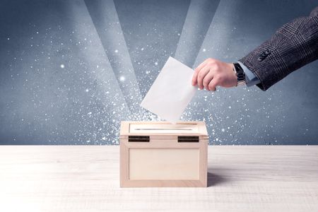 ballot-box-person-casting-vote-sparkling-613349237 Ballot box with person casting vote on sparkling background