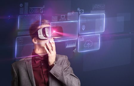 Amazed businessman with virtual reality charts and data in front of him