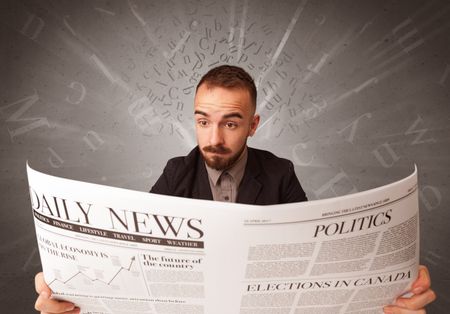 Young smart businessman reading daily newspaper with alphabet letters above his head