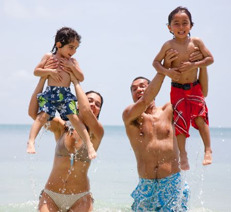 Happy family on holidays playing in the sea