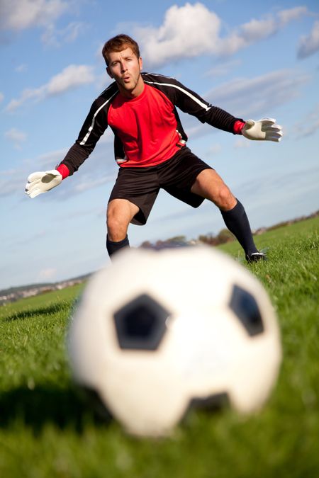 Football goalkeeper ready to catch the ball outdoors