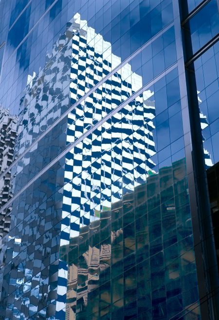 Reflections of skyscrapers on a taller skyscraper