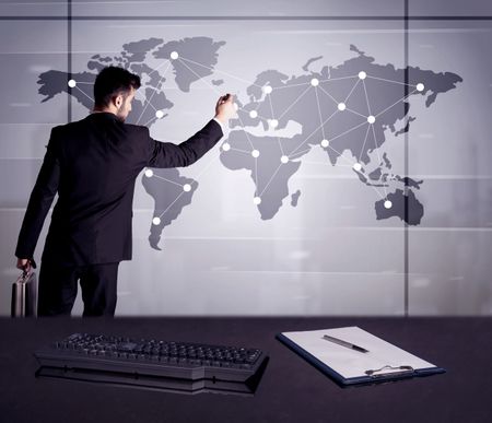 A young office worker drawing on world map and connecting dots with lines, presenting marketing sterategy at office environment concept