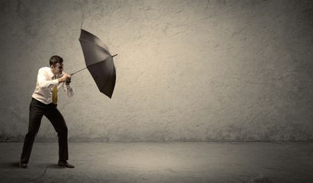 Handsome business man holding umbrella with copy space background concept