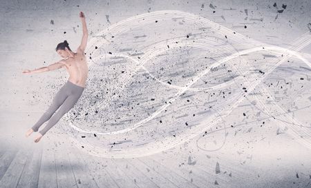 Performance ballet dancer jumping with energy explosion grungy particles concept on background