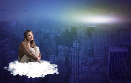 Caucasian woman sitting on a white fluffy cloud above the big city wondering