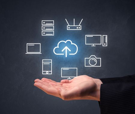 Cloud and computing related icons hovering over young hand