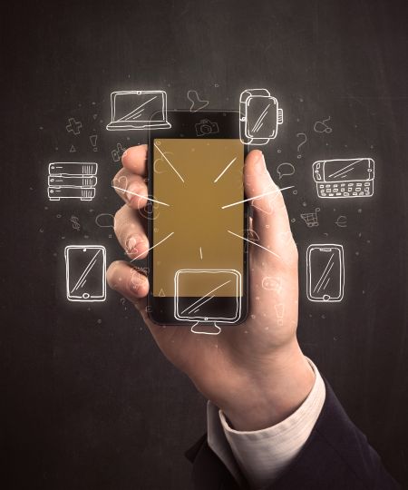 Caucasian hand in business suit holding a smartphone with hand-drawn icons